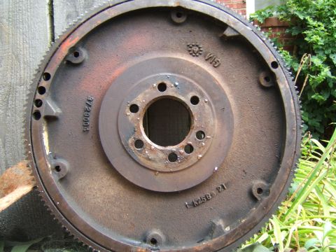 1980 Jeep CJ5 - This rusty flywheel has GM markings and part numbers, indicating it's an engine component.