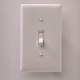 1990 Ford Bronco - Close-up of a standard light switch on a wall.