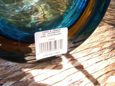 1996 Ford Probe - A glass decanter with a product label is shown on a woven surface.