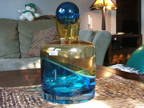 1996 Ford Probe - Decorative glass decanter with a blue sphere stopper sits on a table, with a snowman toy visible on a couch.
