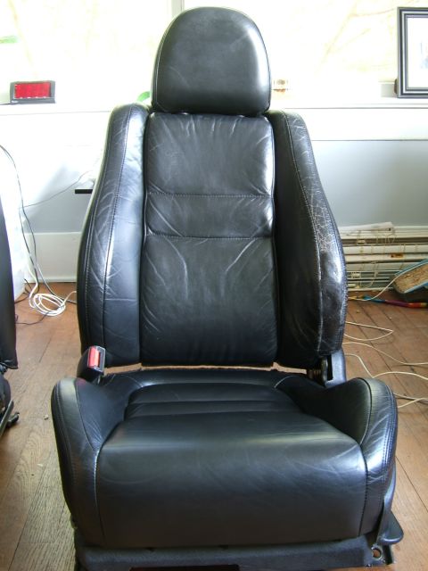 1996 Ford Probe - A black leather car seat is shown from the front, with visible wear on the side bolster.