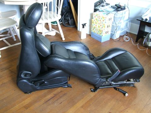 1996 Ford Probe - A pair of black leather car seats, likely from a sports car, are shown disassembled.