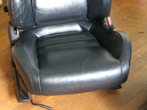 1996 Ford Probe - A black leather car seat, likely from a sporty coupe, shows signs of use and age.