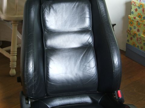 1996 Ford Probe - Close-up of a black leather car seat, showing stitching and some wear.