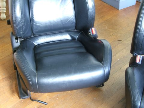 1996 Ford Probe - Two black leather car seats are shown, with one in the foreground and another partially visible to the right.