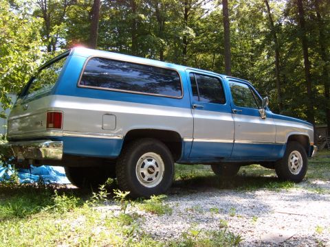 1993 Ford Bronco - This SUV has a distinctive two-tone paint scheme with blue on top and silver on the bottom.