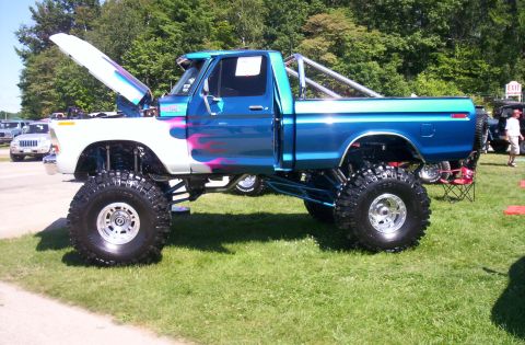 2006 Ford Supercrewzer - A heavily modified pickup truck is displayed outdoors on a grassy area with trees in the background.
