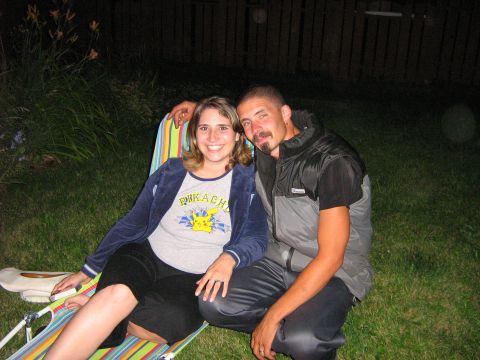 1995 Ford Bronco - A couple relaxes in lawn chairs outdoors at night, with the woman sporting a Pikachu t-shirt.