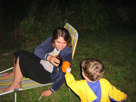 1995 Ford Bronco - A woman and child share a drink outdoors at night, with a cigarette in the woman's hand.