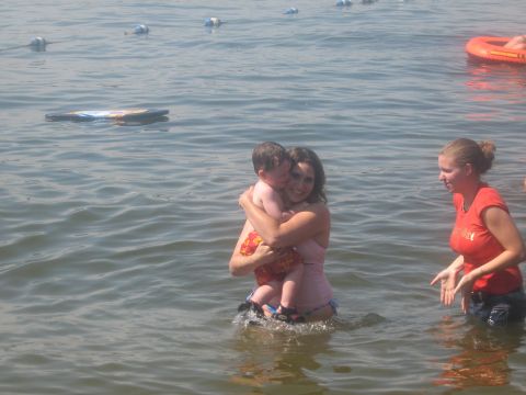 1995 Ford Bronco - People enjoying a day at the lake with buoys and a float in the background.