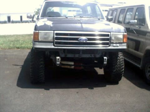 1996 Ford Bronco - This lifted truck, likely from the late 1980s, is shown from the front with a winch mounted below the bumper.