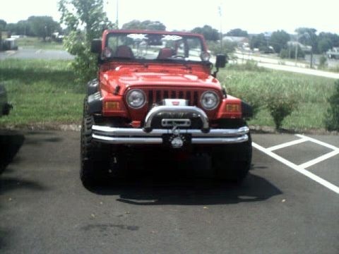 1996 Ford Bronco - This red Jeep Wrangler is shown from the front, a winch and custom bumper.