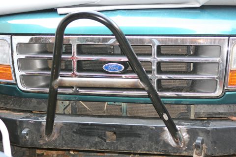 1996 Ford Bronco - Front view of a green 1996 Ford Bronco a chrome grille and a custom brush guard over the bumper.