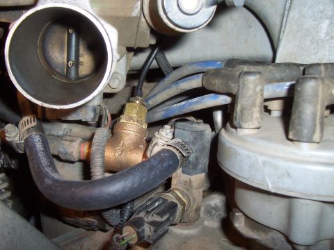 1994 Ford F-150 - Close-up of engine components including a throttle body and distributor cap.