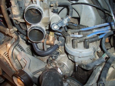 1994 Ford F-150 - A detailed view of various engine components, focusing on the intake and ignition systems.