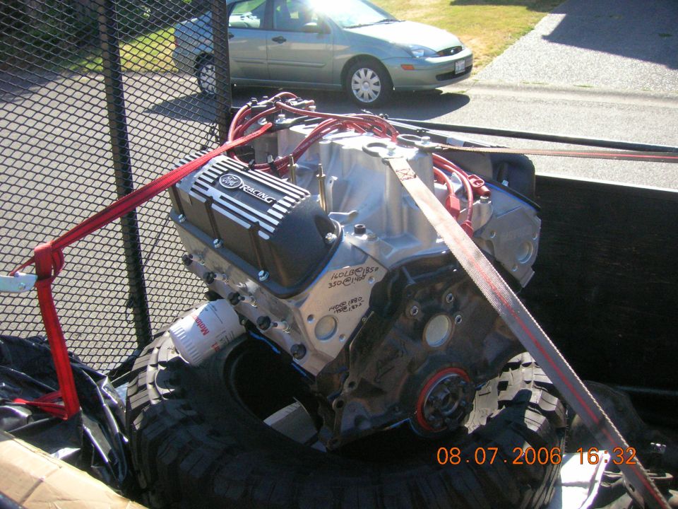 Ford Racing engine with silver valve covers, red spark plug wires, and an oil filter