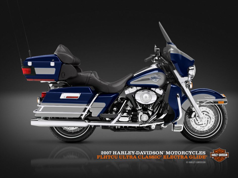 Blue and silver Harley-Davidson motorcycle, side view, with saddlebags and windshield