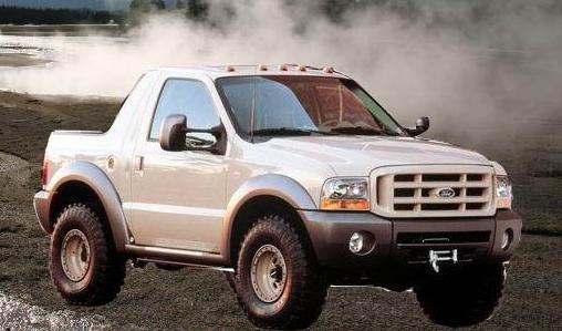 White pickup truck with a cap, 3/4 front view, showing a beige grille and fender flares