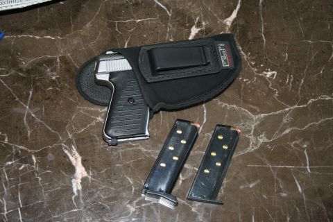 2004 Jeep TJ - A pistol and its magazines are laid out on a marble countertop.