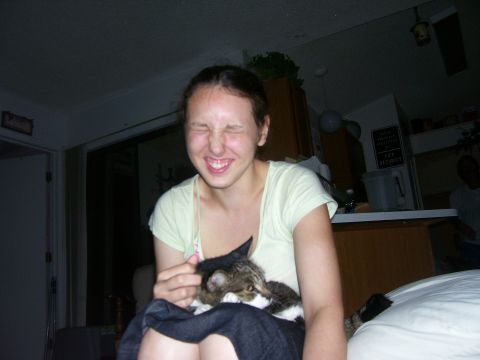 1994 Ford Probe - A woman makes a funny face while holding a cat.