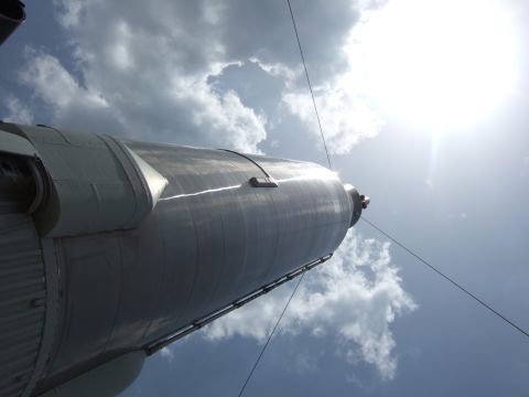 1994 Ford Probe - A rocket is seen from a low angle against a bright, cloudy sky.