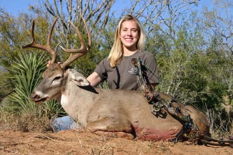 1986 Ford Bronco - A woman poses with a harvested deer and bow in a natural outdoor setting.