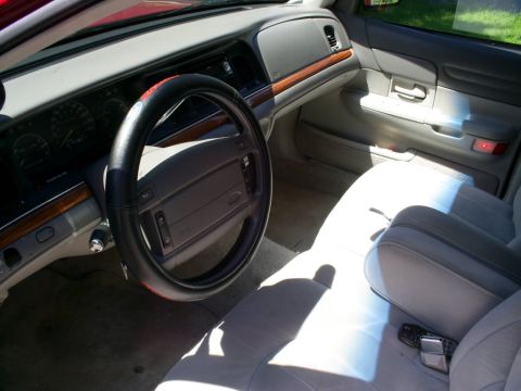 1995 Ford Crown Victoria - The interior of a 1995 Ford Crown Victoria shows gray cloth seats and dashboard details.