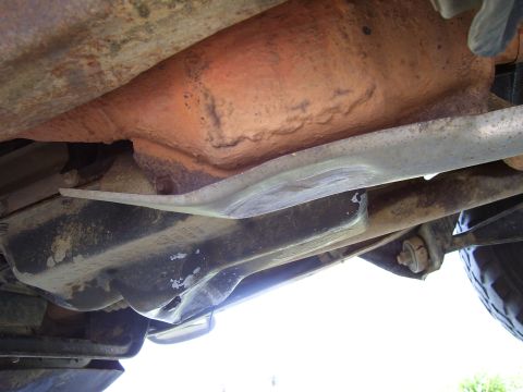 1992 Ford Bronco - Close-up view of a vehicle's undercarriage, revealing its mechanical components and frame structure.