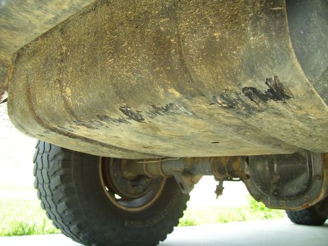 1992 Ford Bronco - Underside view of a vehicle, focusing on the fuel tank and rear axle components.