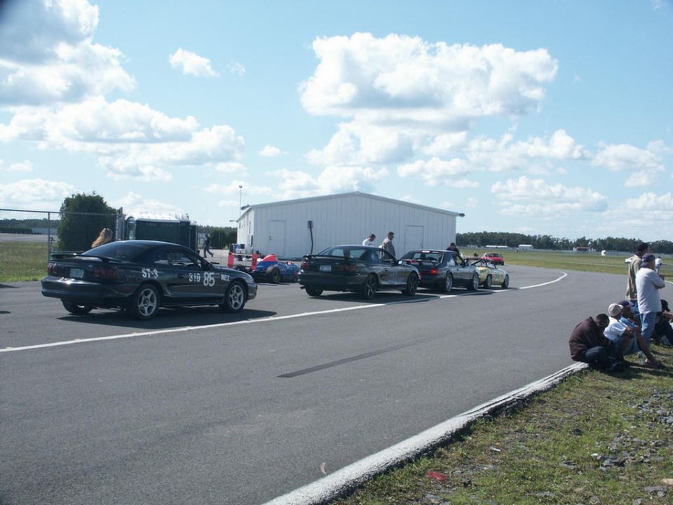 Black coupe with racing numbers ST-9 219 85 on a racetrack