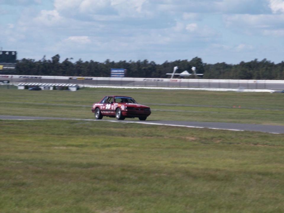 Red race car with number 20 on a track