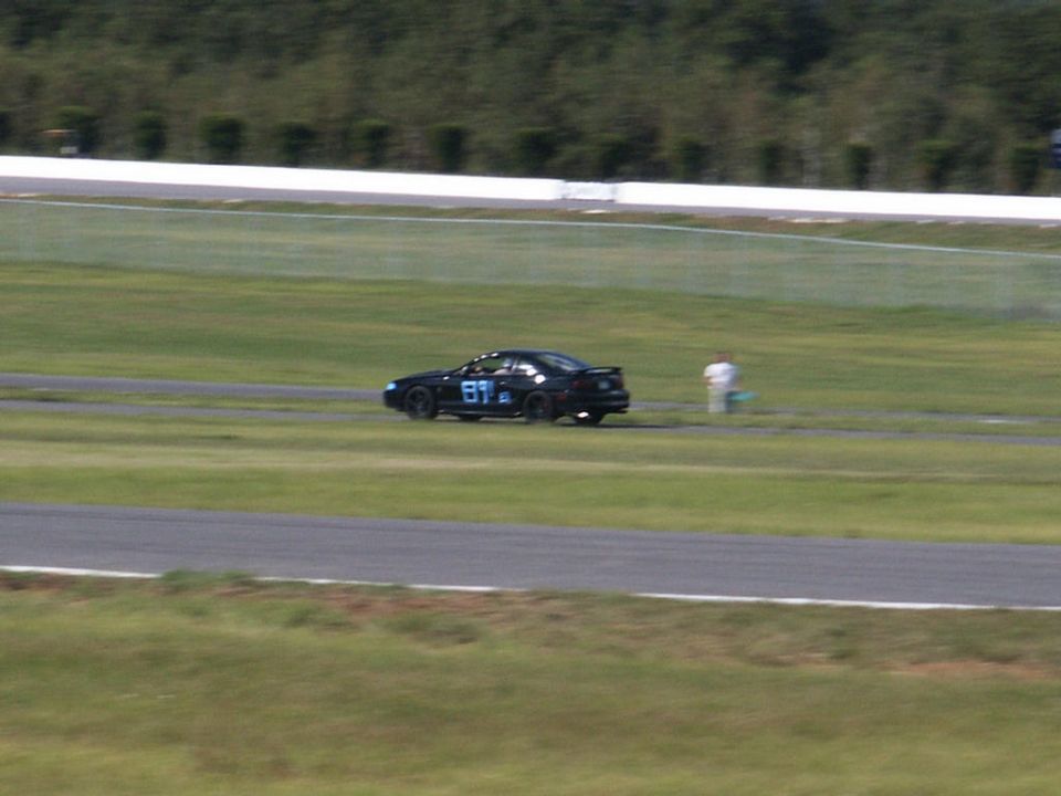 Black sedan with racing number 89 on a track