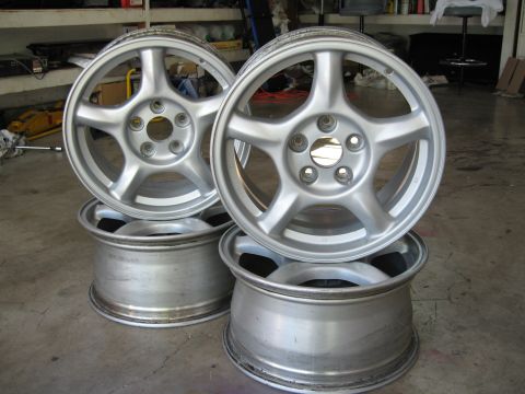1994 Ford Probe - Set of four aluminum alloy wheels, likely aftermarket or OEM replacement parts.