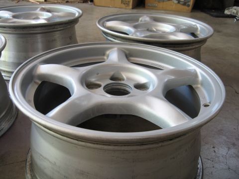 1994 Ford Probe - A set of five-spoke alloy wheels are shown, likely for a car.