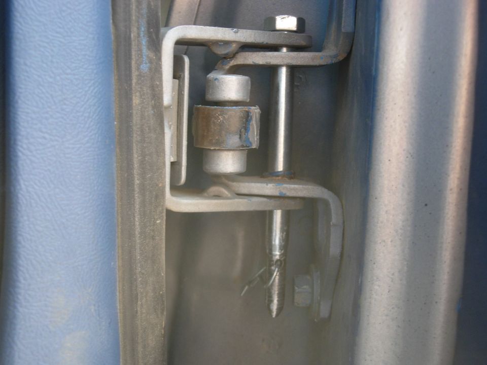 Dropped in the hinge with a hole drilled for a cotter pin.  They fit very snug, so the pin's not really necassary.