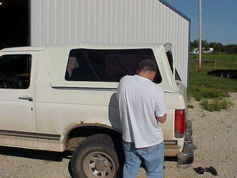 1987 Ford Bronco - At 4:10 PM, we were doing the snaps for the sides. Still had to put the bracket in for the tailgate and the snaps there too.