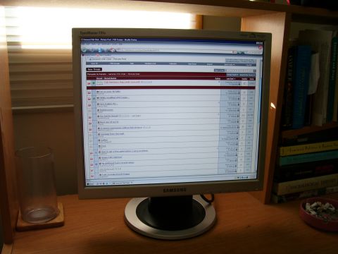 1984 Ford Bronco - A computer monitor shows a forum page with multiple discussion threads visible on screen.