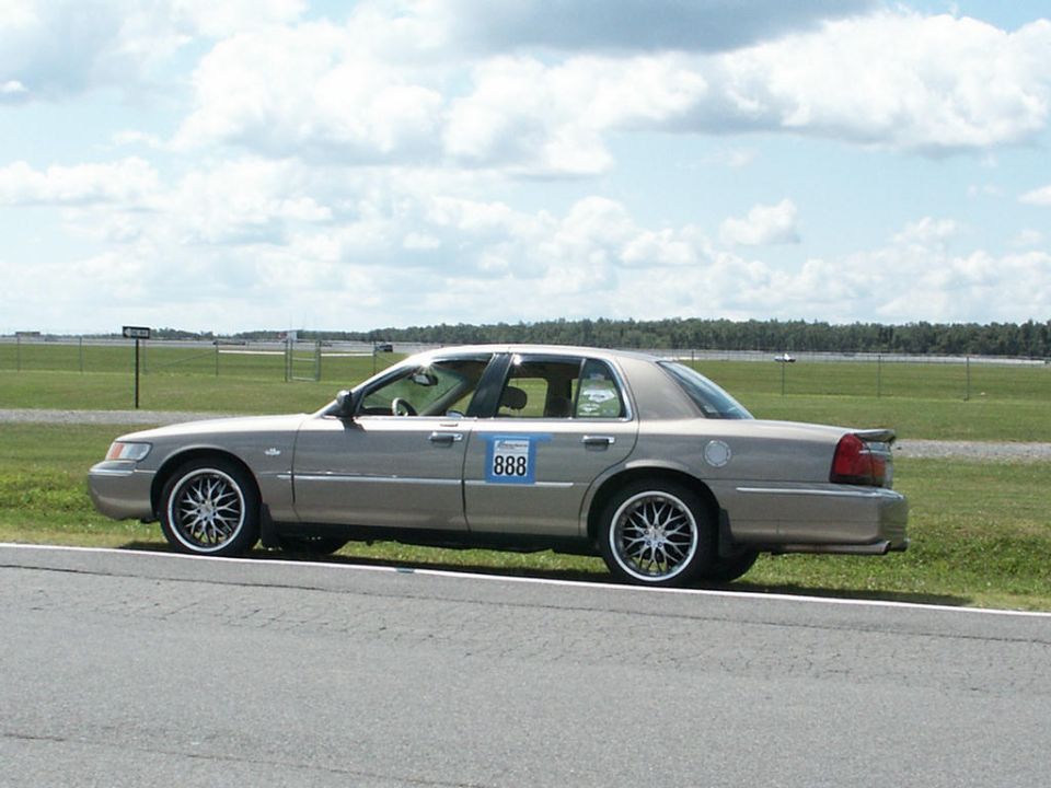 Tan 2001 Mercury Grand Marquis side view with racing number 888