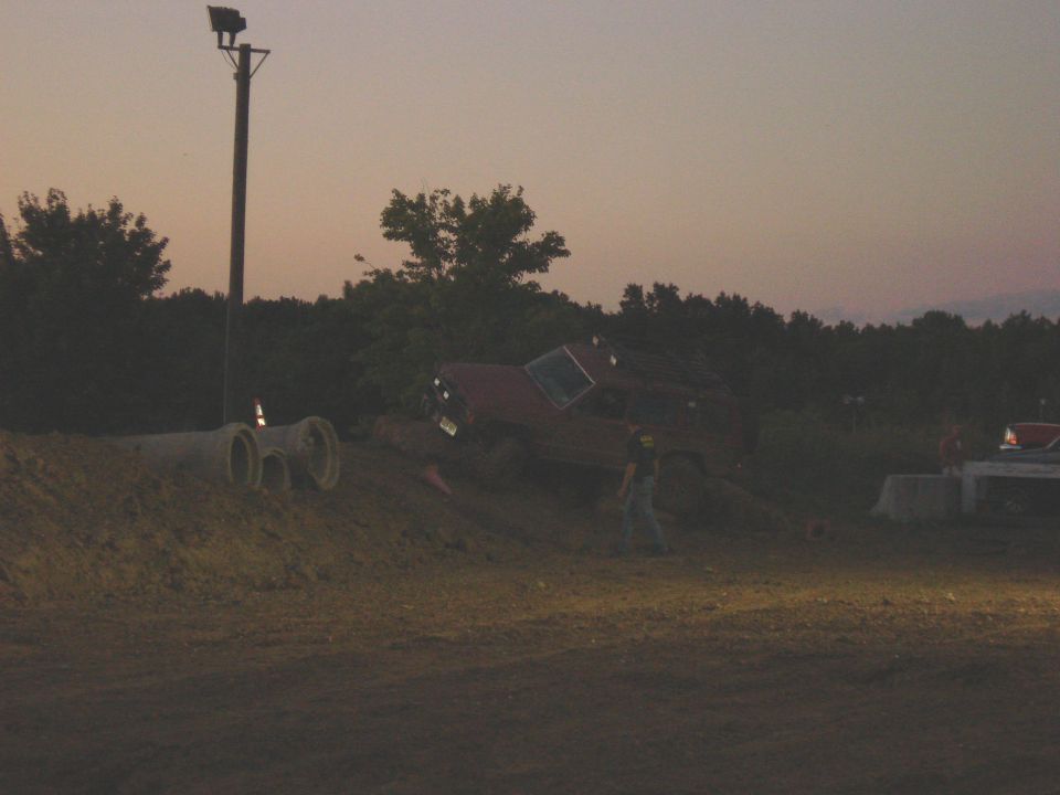 Red SUV on its side with a person standing nearby