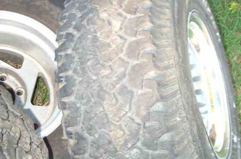 1988 Ford Bronco - Two tires and rims are shown in this close-up image.