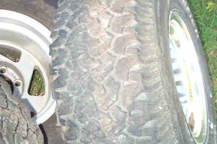 close-up of two off-road tires and alloy rims