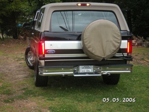 1996 Ford Bronco - This 1996 Ford Bronco features a two-tone paint scheme and a spare tire mounted on the rear tailgate.