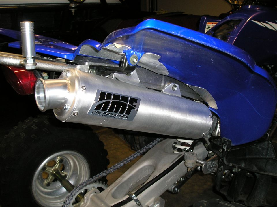 HMF Performance aluminum slip-on exhaust on a blue sport quad in a garage