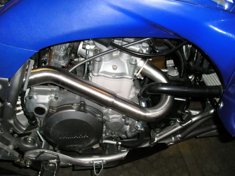 1993 Ford Bronco - Close-up of a Yamaha motorcycle engine, showing the exhaust and blue bodywork.