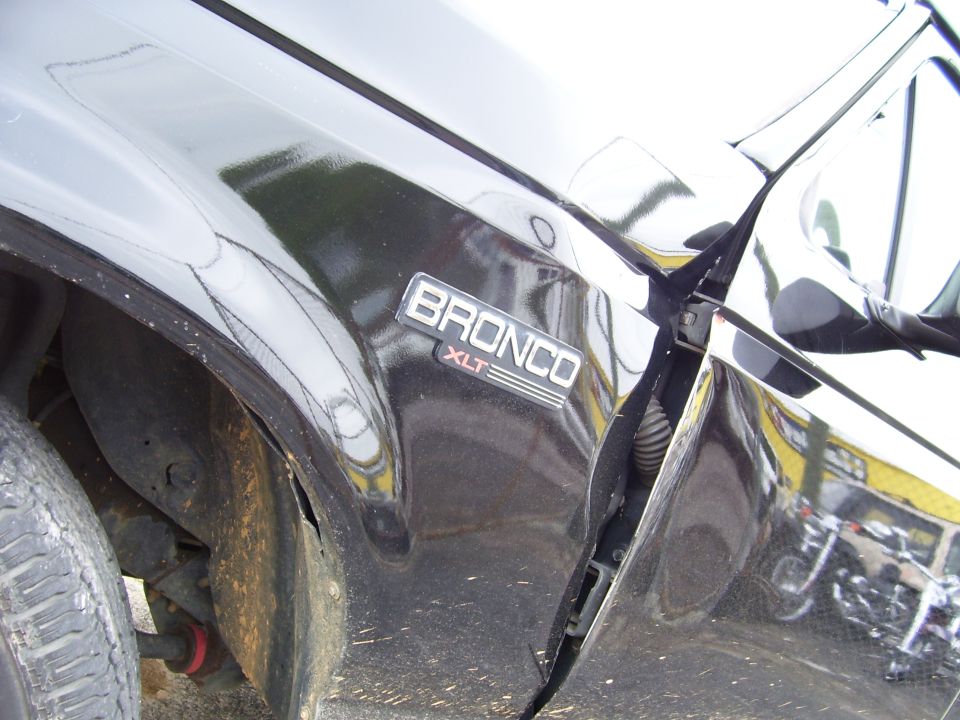 Black SUV front fender with BRONCO XLT badge and side mirror