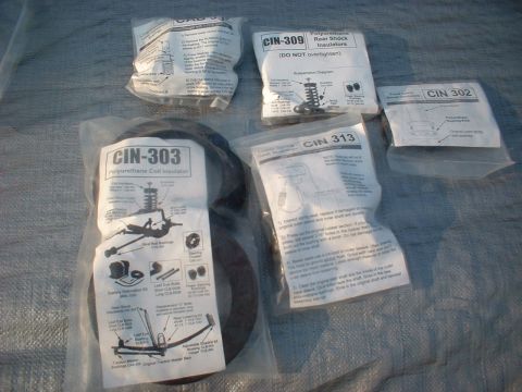 1969 Ford Mustang - A collection of polyurethane suspension components, including coil and shock insulators, are displayed.