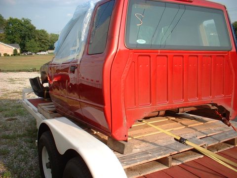 1999 Ford Ranger - 1999 Ford Ranger truck cab being transported on a trailer.