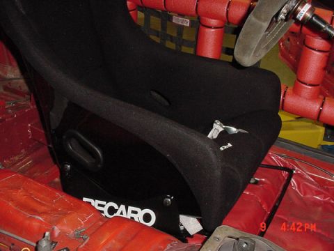 1993 Ford Mustang - Interior view of a car's racing seat and roll cage, with the RECARO brand visible on the seat.