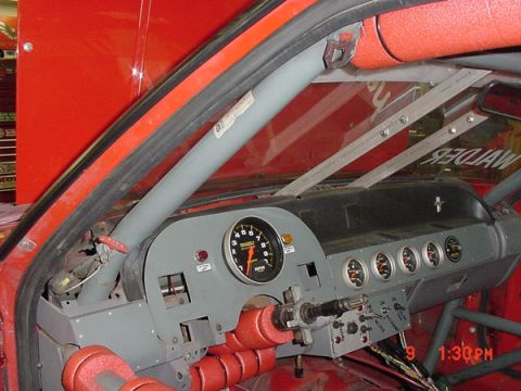 1993 Ford Mustang - Customized interior of a racing car, a modified dashboard and safety roll cage.