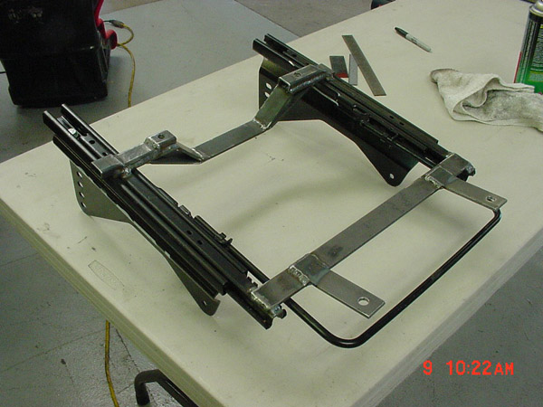 Custom seat bracket with metal sliders and mounting points